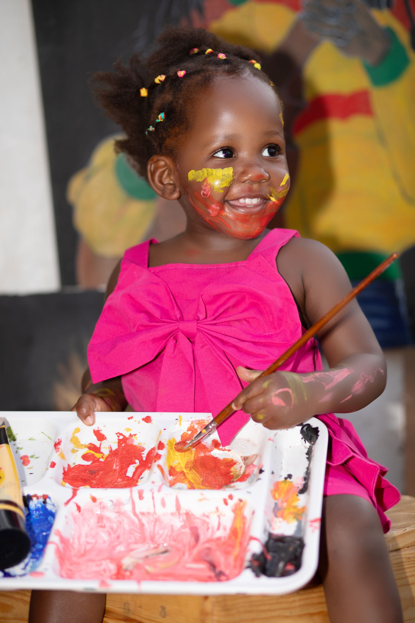 A young child painting during a Pearl Quest art lesson
