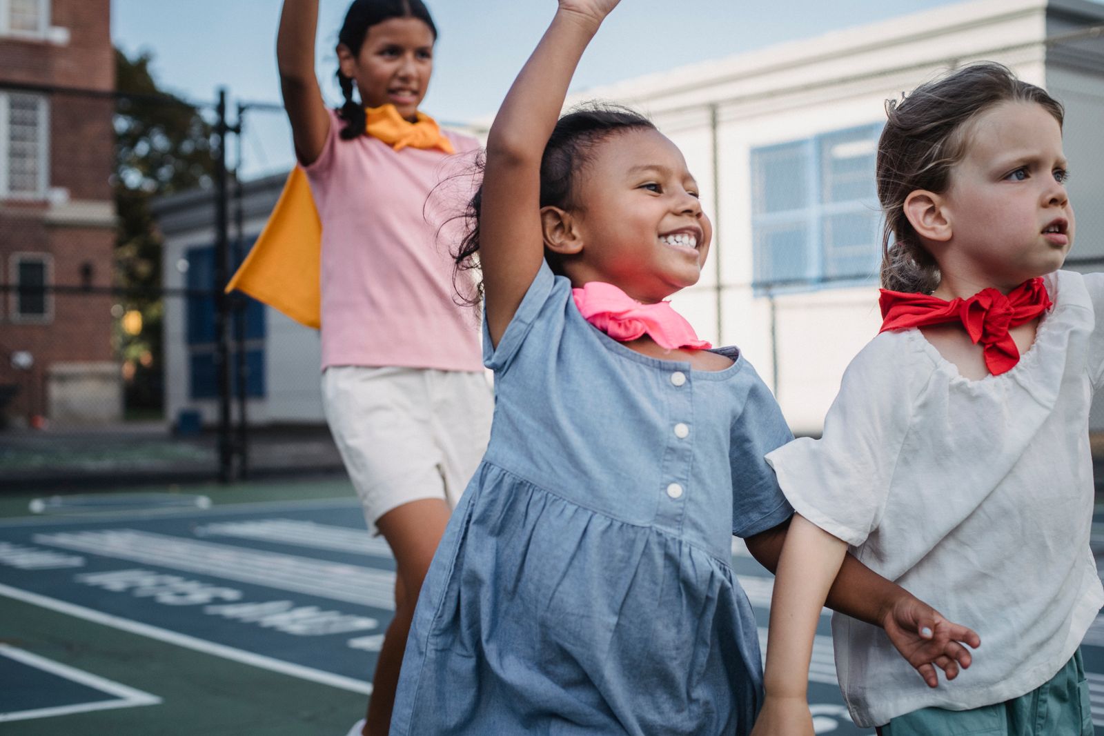 A Pearl Quest pupil laughing with friends during outdoor play