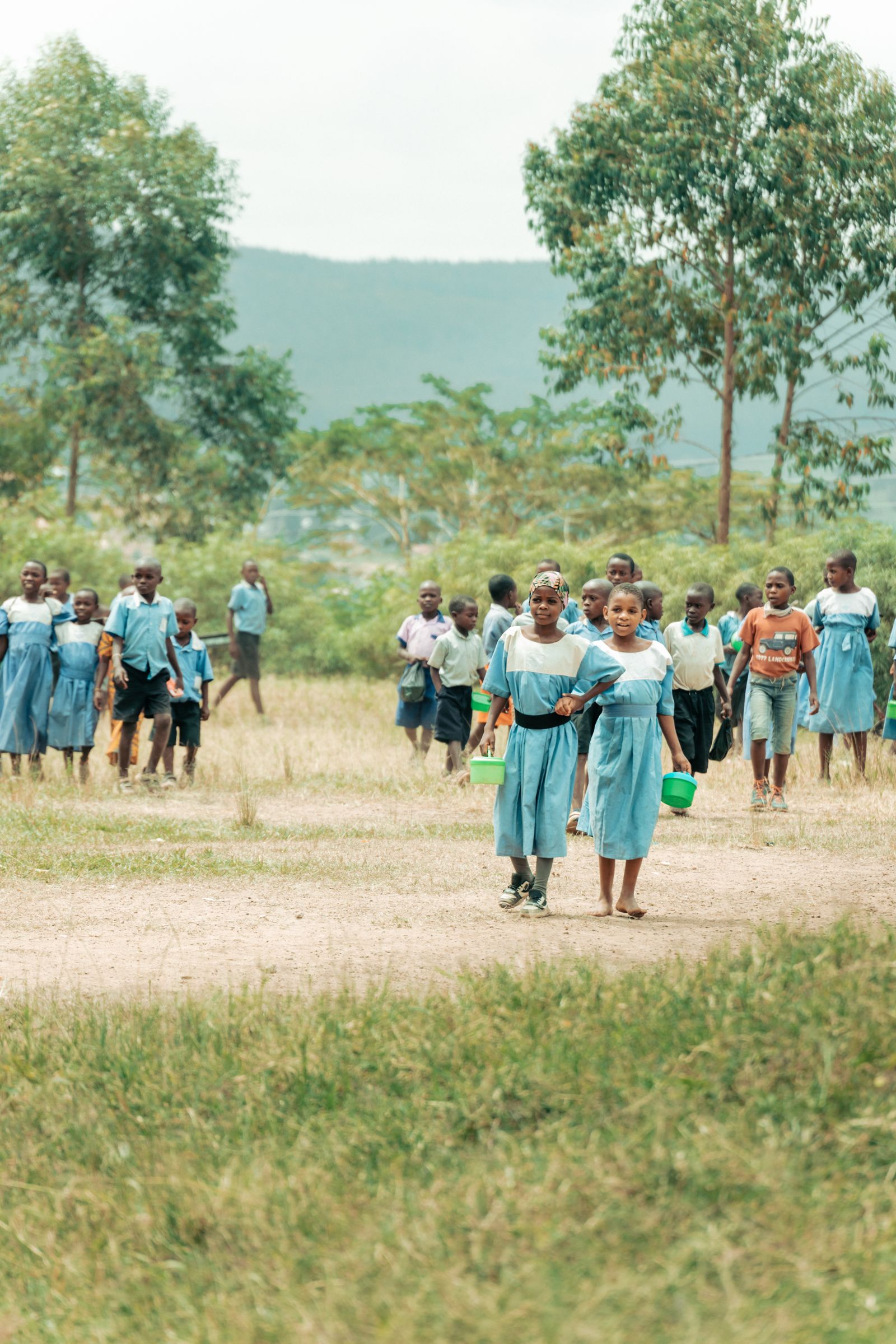 Pupils in Pearl Quest uniform walking together across the school grounds
